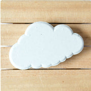 cloud shaped bath bomb on brown wood background
